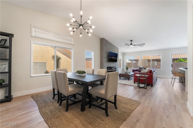 9705 Standard Ave, Las Vegas, NV 89129 - dining area with a chandelier, light wood finished floors, baseboards, and vaulted ceiling