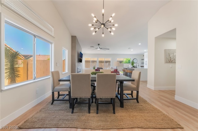 9705 Standard Ave, Las Vegas, NV 89129 - dining area with a chandelier, light wood-style floors, and baseboards