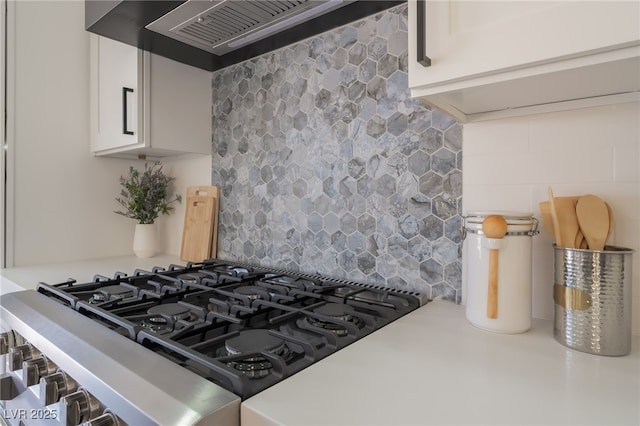 9705 Standard Ave, Las Vegas, NV 89129 - kitchen featuring custom exhaust hood, stainless steel range with gas cooktop, decorative backsplash, and light countertops