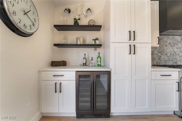 9705 Standard Ave, Las Vegas, NV 89129 - indoor dry bar featuring beverage cooler, decorative backsplash, ventilation hood, and range with gas stovetop