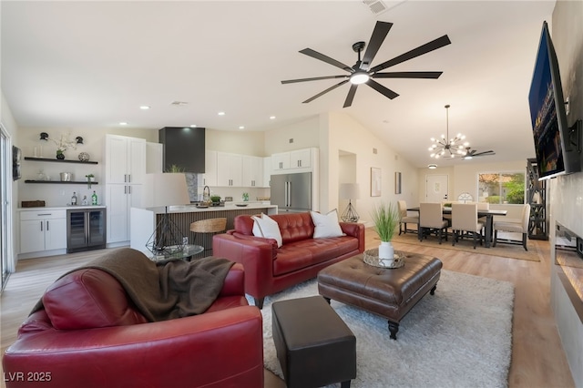 9705 Standard Ave, Las Vegas, NV 89129 - living room featuring beverage cooler, a chandelier, bar, light wood-style floors, and ceiling fan