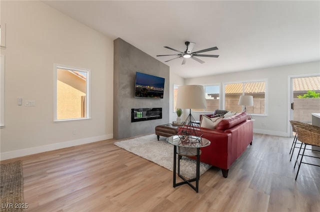 9705 Standard Ave, Las Vegas, NV 89129 - living room with light wood-style flooring, ceiling fan, baseboards, and a fireplace