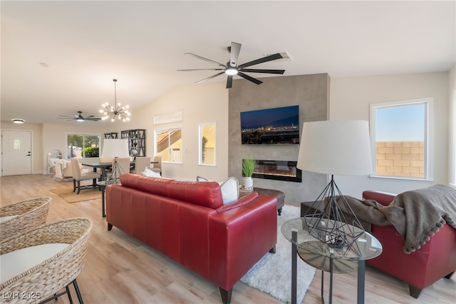 9705 Standard Ave, Las Vegas, NV 89129 - living area featuring a ceiling fan, a large fireplace, wood finished floors, a chandelier, and lofted ceiling