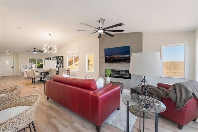 9705 Standard Ave, Las Vegas, NV 89129 - living area featuring ceiling fan, a fireplace, light wood-type flooring, a chandelier, and lofted ceiling