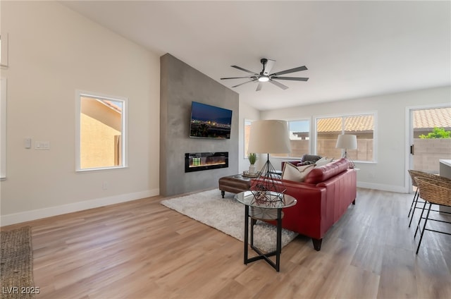 9705 Standard Ave, Las Vegas, NV 89129 - living area with light wood-style flooring, a ceiling fan, baseboards, and a large fireplace