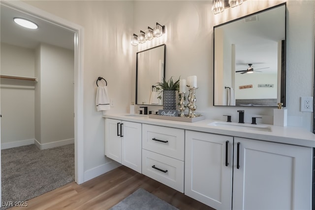 9705 Standard Ave, Las Vegas, NV 89129 - full bathroom with double vanity, wood finished floors, ceiling fan, and baseboards