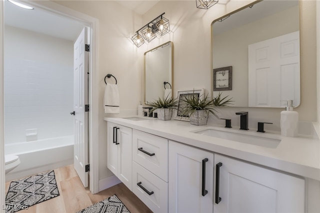 9705 Standard Ave, Las Vegas, NV 89129 - bathroom with double vanity, toilet, and wood finished floors