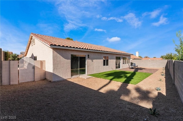 9705 Standard Ave, Las Vegas, NV 89129 - back of property with stucco siding, a tiled roof, and a fenced backyard