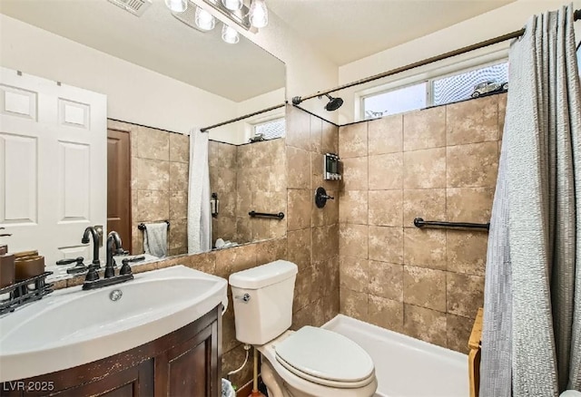 3473 Conough Ln, Las Vegas, NV 89129 - full bath featuring toilet, vanity, a tile shower, and tile walls