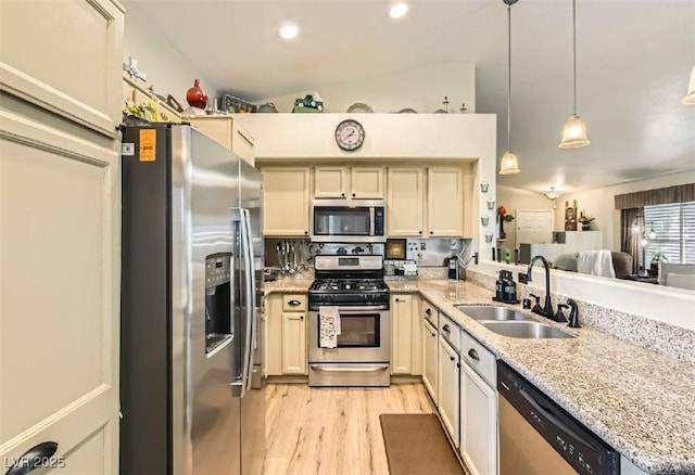 3473 Conough Ln, Las Vegas, NV 89129 - kitchen featuring stainless steel appliances, a sink, light wood-type flooring, a peninsula, and light stone countertops