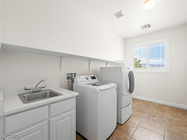 5120 Mirage Garden St, Las Vegas, NV 89130 - laundry room with washer and dryer, baseboards, light tile patterned floors, and cabinet space