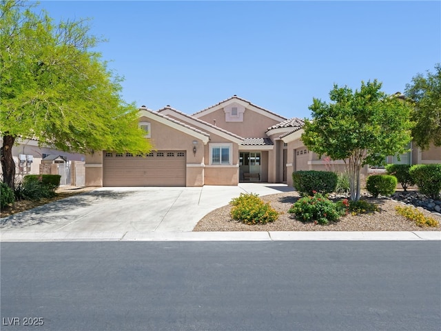 5120 Mirage Garden St, Las Vegas, NV 89130 - view of front of property with an attached garage, stucco siding, concrete driveway, and a tiled roof