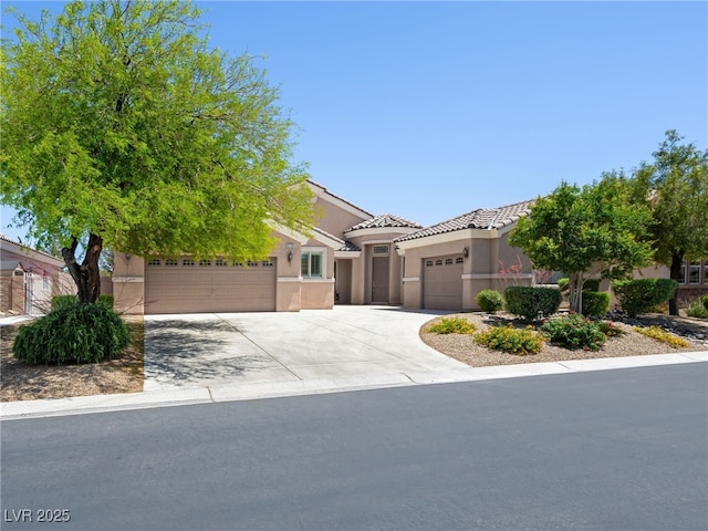 5120 Mirage Garden St, Las Vegas, NV 89130 - view of front of house featuring an attached garage, stucco siding, driveway, and a tiled roof