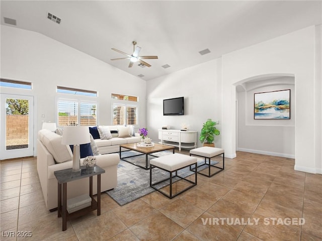 5120 Mirage Garden St, Las Vegas, NV 89130 - living room with ceiling fan, tile patterned floors, high vaulted ceiling, arched walkways, and baseboards
