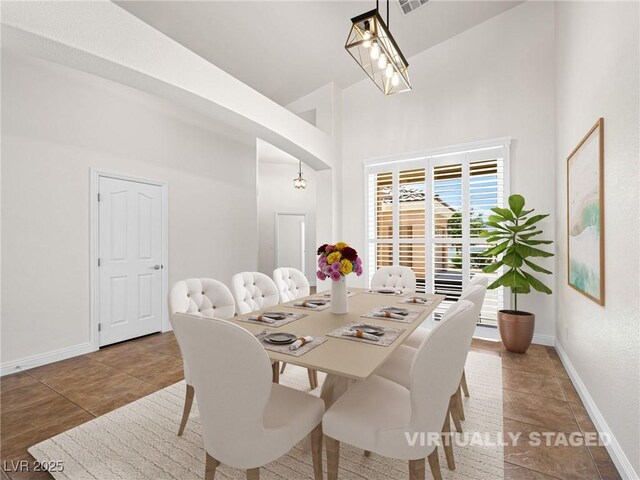 5120 Mirage Garden St, Las Vegas, NV 89130 - dining area with baseboards, a high ceiling, and tile patterned flooring