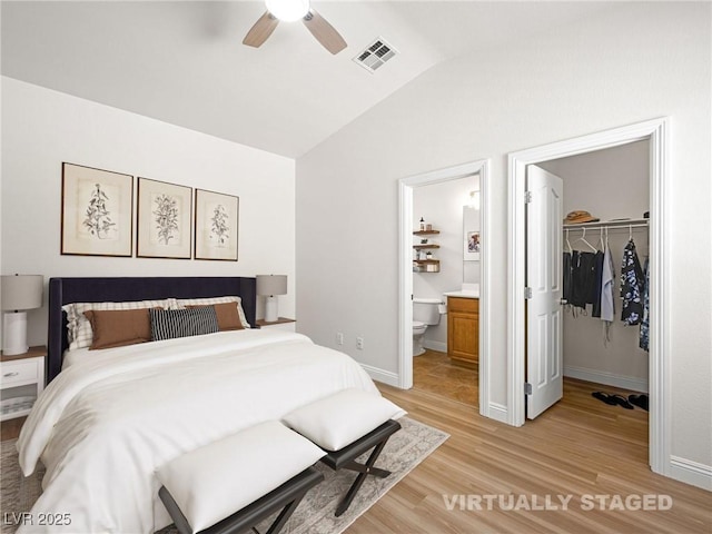 5120 Mirage Garden St, Las Vegas, NV 89130 - bedroom featuring lofted ceiling, a spacious closet, light wood-style flooring, a closet, and connected bathroom