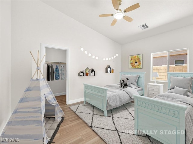 5120 Mirage Garden St, Las Vegas, NV 89130 - bedroom featuring wood finished floors, a spacious closet, baseboards, ceiling fan, and a closet