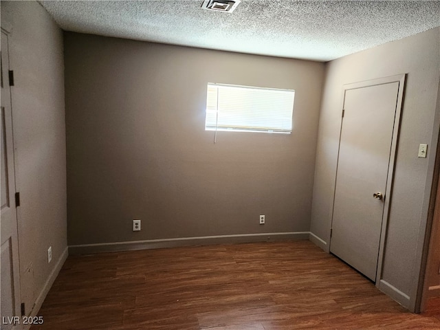 377 N 16th St, Las Vegas, NV 89101 - empty room with wood finished floors, a textured ceiling, and baseboards