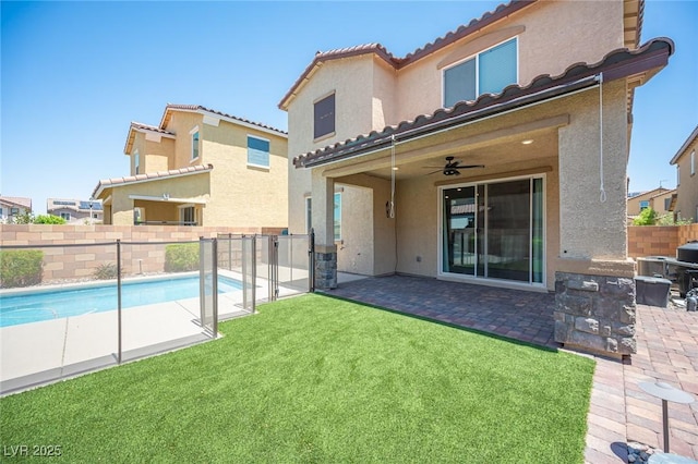871 Aurelie Ridge St, Henderson, NV 89011 - back of property with stucco siding, area for grilling, a tiled roof, a patio area, and ceiling fan