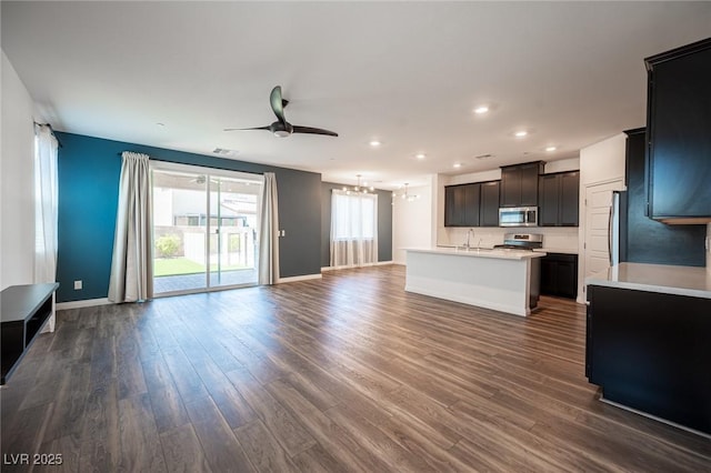 871 Aurelie Ridge St, Henderson, NV 89011 - unfurnished living room with a chandelier, ceiling fan, a sink, dark wood-style flooring, and recessed lighting