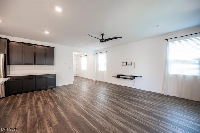 871 Aurelie Ridge St, Henderson, NV 89011 - unfurnished living room featuring a ceiling fan, dark wood-style floors, recessed lighting, and baseboards