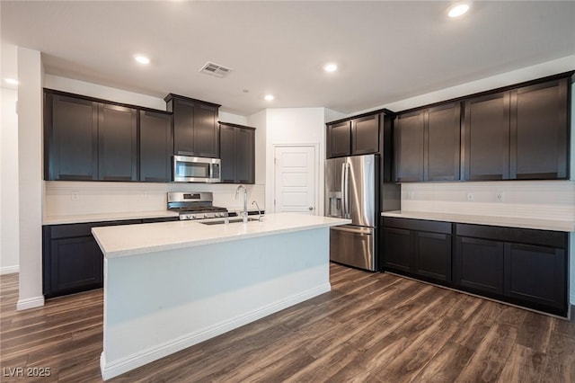 871 Aurelie Ridge St, Henderson, NV 89011 - kitchen featuring appliances with stainless steel finishes, a sink, dark wood-type flooring, backsplash, and recessed lighting