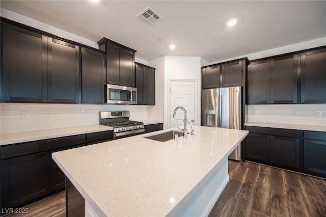 871 Aurelie Ridge St, Henderson, NV 89011 - kitchen with appliances with stainless steel finishes, a sink, dark wood-style flooring, tasteful backsplash, and recessed lighting