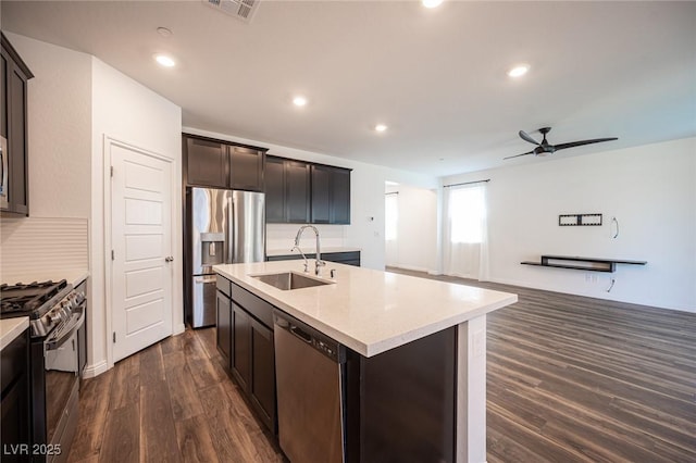 871 Aurelie Ridge St, Henderson, NV 89011 - kitchen featuring stainless steel appliances, a sink, dark wood finished floors, ceiling fan, and a center island with sink