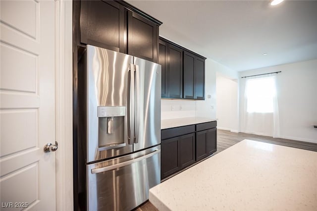 871 Aurelie Ridge St, Henderson, NV 89011 - kitchen featuring stainless steel refrigerator with ice dispenser, recessed lighting, light stone counters, and light wood-type flooring