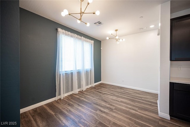 871 Aurelie Ridge St, Henderson, NV 89011 - unfurnished dining area with a chandelier, wood finished floors, and baseboards