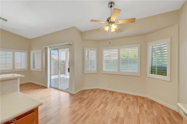 4197 Bottiglia Ave, Las Vegas, NV 89141 - unfurnished dining area featuring light wood-type flooring, healthy amount of natural light, baseboards, vaulted ceiling, and a ceiling fan