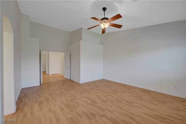 4197 Bottiglia Ave, Las Vegas, NV 89141 - unfurnished room with light wood-type flooring, a ceiling fan, a high ceiling, and baseboards