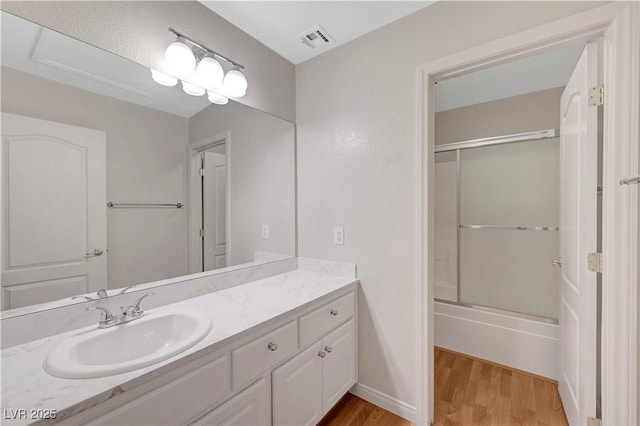 4197 Bottiglia Ave, Las Vegas, NV 89141 - bathroom with vanity, wood finished floors, and shower / bath combination with glass door