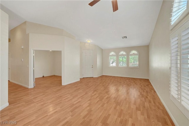 4197 Bottiglia Ave, Las Vegas, NV 89141 - unfurnished living room with vaulted ceiling, light wood-style floors, ceiling fan, and baseboards