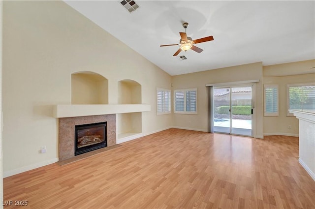 4197 Bottiglia Ave, Las Vegas, NV 89141 - unfurnished living room featuring a fireplace, light wood finished floors, a ceiling fan, baseboards, and lofted ceiling
