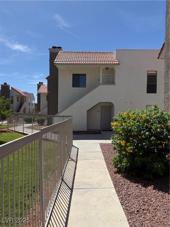 2212 Sunfish Dr Unit D, Henderson, NV 89014 - mediterranean / spanish-style home with stucco siding, a tile roof, and a chimney