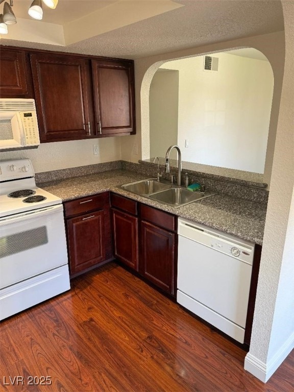 2212 Sunfish Dr Unit D, Henderson, NV 89014 - kitchen with white appliances, a sink, arched walkways, and dark wood finished floors