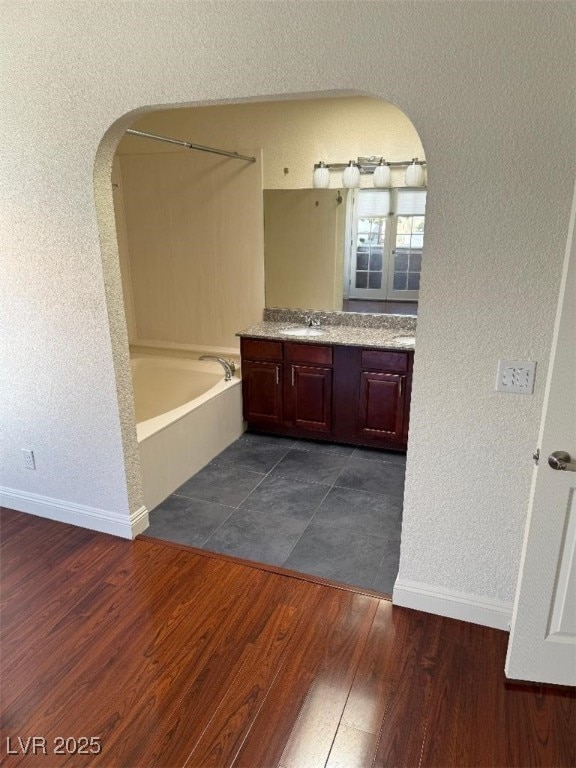 2212 Sunfish Dr Unit D, Henderson, NV 89014 - bathroom featuring vanity, baseboards, shower / bathtub combination, wood finished floors, and a textured wall