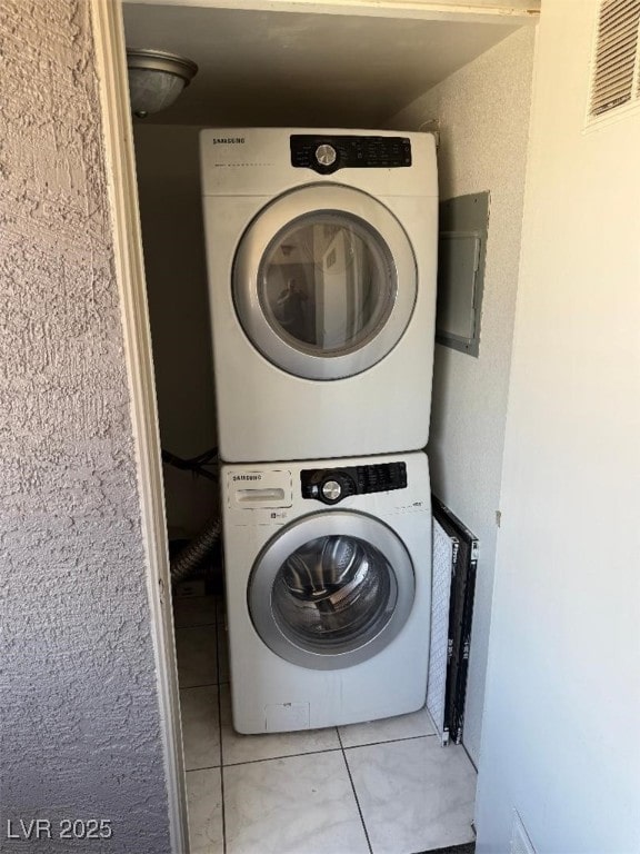 2212 Sunfish Dr Unit D, Henderson, NV 89014 - laundry room with stacked washer / dryer and light tile patterned flooring