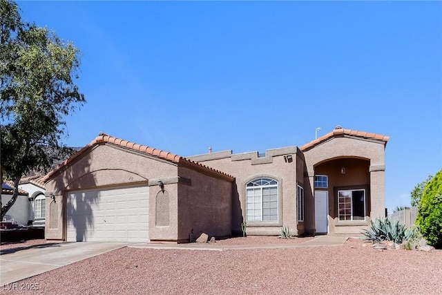 472 Tiger Lily Way, Henderson, NV 89015 - mediterranean / spanish home featuring an attached garage, driveway, stucco siding, and a tile roof