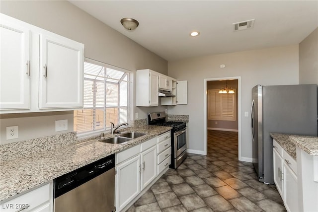 472 Tiger Lily Way, Henderson, NV 89015 - kitchen featuring appliances with stainless steel finishes, a sink, under cabinet range hood, white cabinets, and baseboards