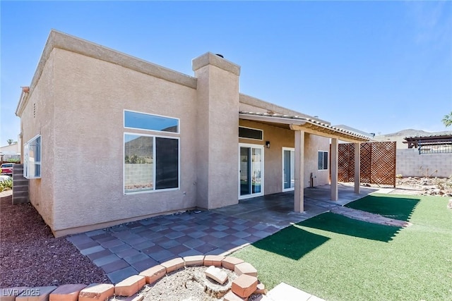 472 Tiger Lily Way, Henderson, NV 89015 - back of house with stucco siding and a patio area