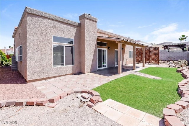 472 Tiger Lily Way, Henderson, NV 89015 - rear view of property featuring stucco siding, a patio, and a chimney
