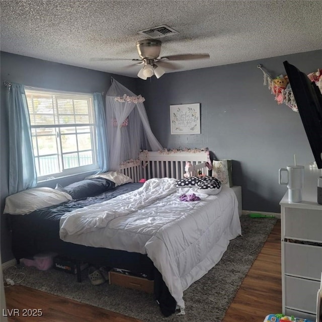 6231 Santa Maria Ave, Las Vegas, NV 89108 - bedroom featuring wood finished floors, a ceiling fan, a textured ceiling, and baseboards