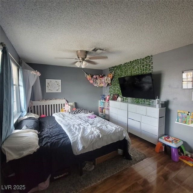 6231 Santa Maria Ave, Las Vegas, NV 89108 - bedroom featuring wood finished floors, multiple windows, a textured ceiling, and a ceiling fan