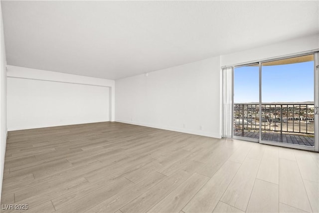 3111 Bel Air Dr Unit 24G, Las Vegas, NV 89109 - spare room featuring wood finished floors