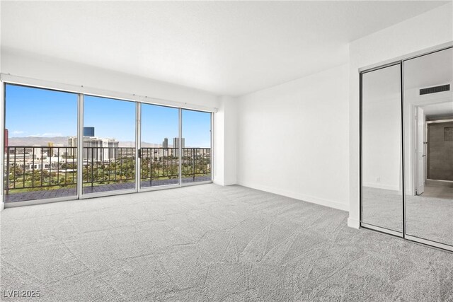 3111 Bel Air Dr Unit 24G, Las Vegas, NV 89109 - unfurnished bedroom featuring carpet and access to exterior