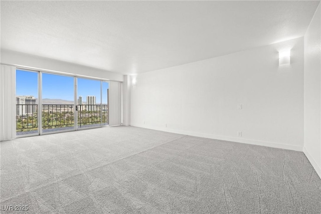 3111 Bel Air Dr Unit 24G, Las Vegas, NV 89109 - spare room featuring carpet and baseboards