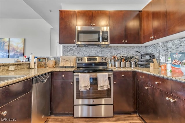 8255 Las Vegas Blvd Unit 719, Las Vegas, NV 89123 - kitchen with appliances with stainless steel finishes, light stone countertops, backsplash, and light wood finished floors