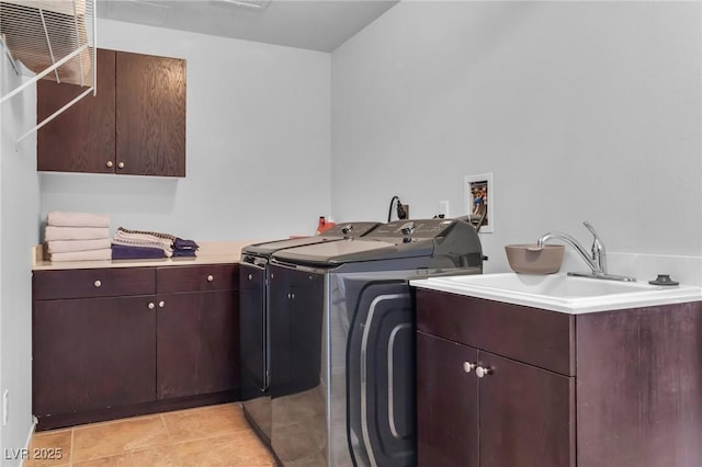 8255 Las Vegas Blvd Unit 719, Las Vegas, NV 89123 - laundry room with cabinet space, washer and clothes dryer, and light tile patterned floors